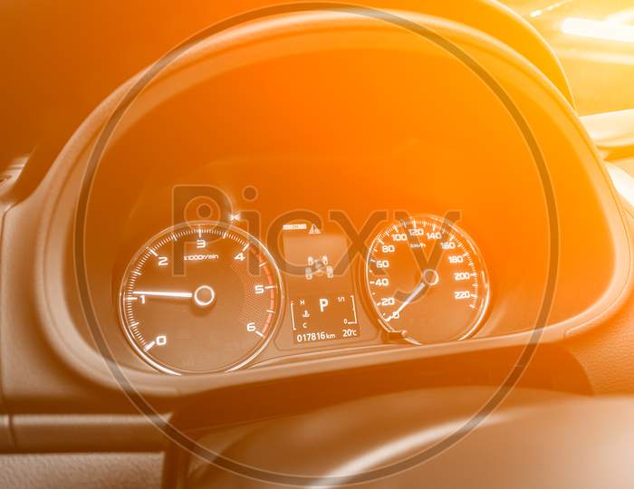 Speedometer Of A Modern Car With An Integrated Fuel Gauge In The Tank With White Arrows Under The Yellow And Orange Neon Color