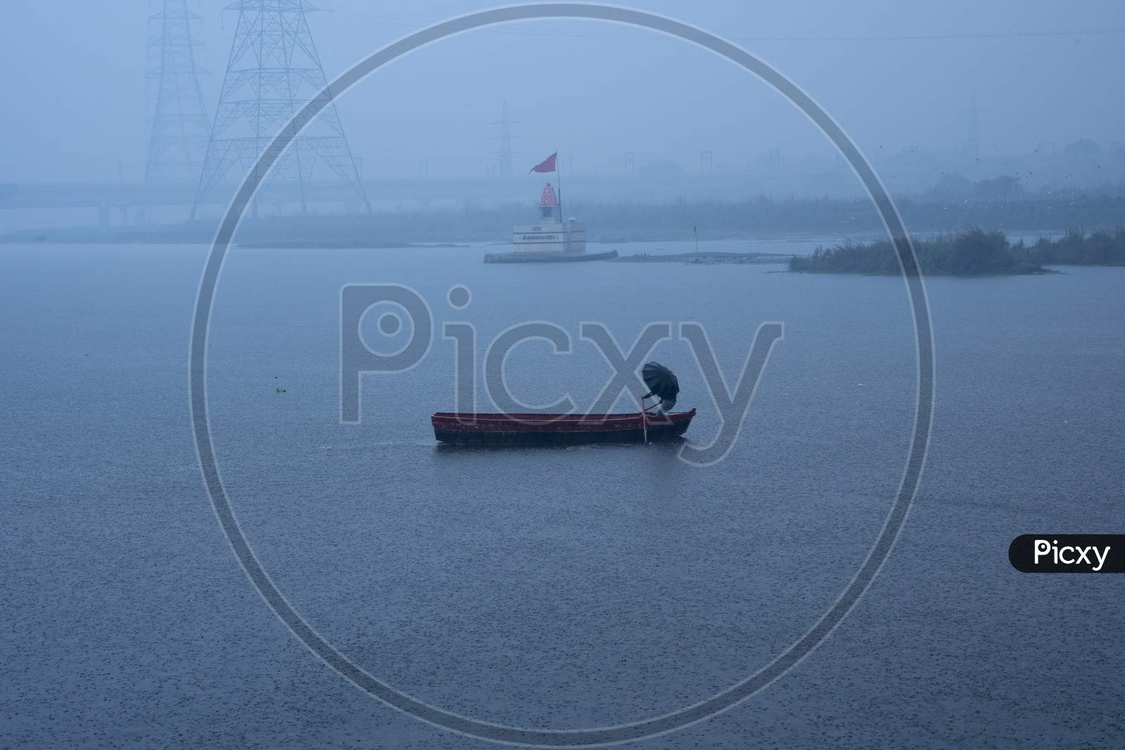 A Boat Man Crossing River During Rainfall