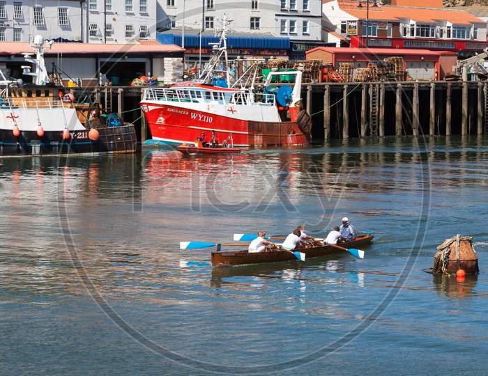 Unidentified Man And Boys Exhausted At The End Of A Rowing Boat Race In Whitby