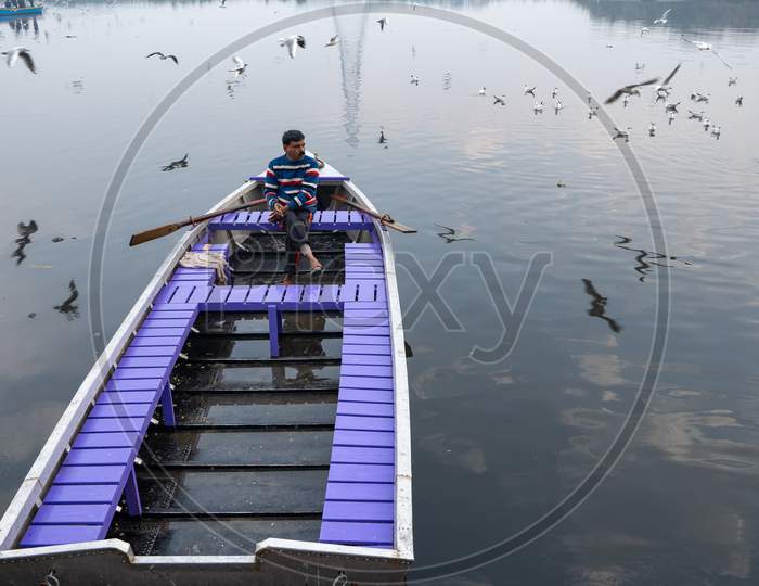 A Boatman In Yamuna Ghat Waiting For Customers
