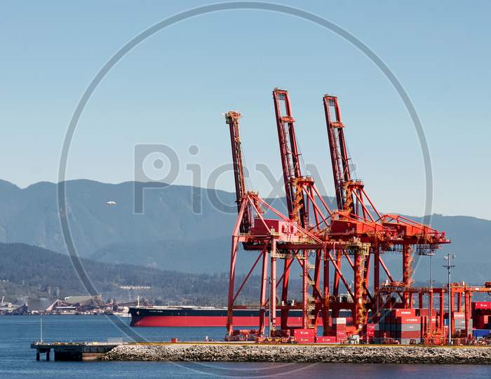 Red Cranes In Vancouver Harbour
