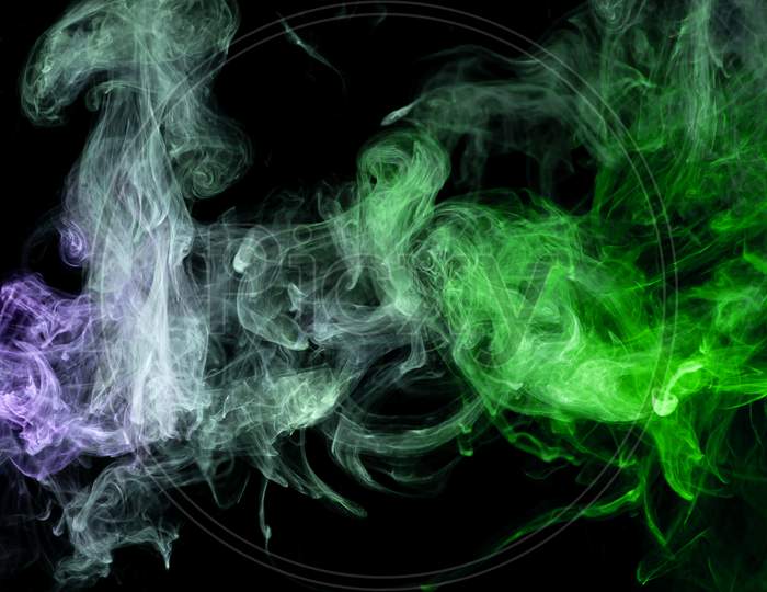 Frozen Abstract Movement Of  Explosion Smoke Multiple Blue And Greencolors On Black Background. Background From The Smoke Of Vape