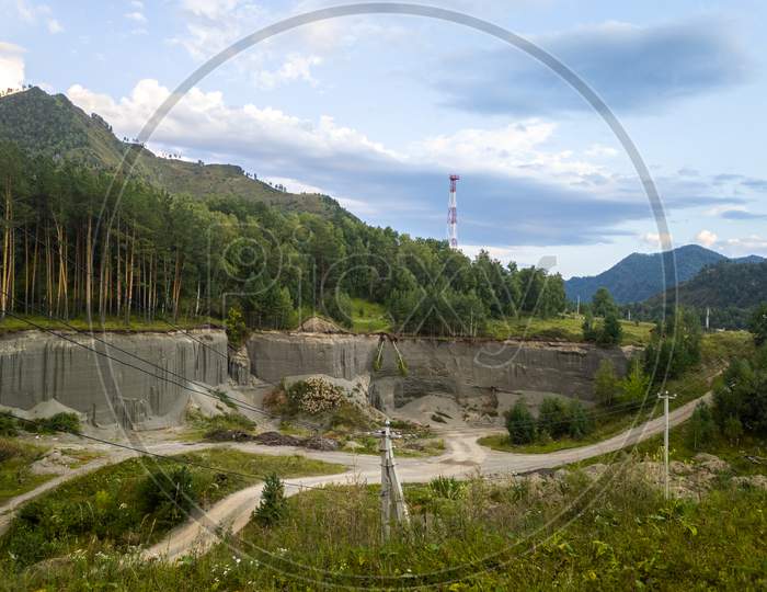 A Natural Quarry For The Extraction Of Sand, Clay Near A Green Forest In The Mountains