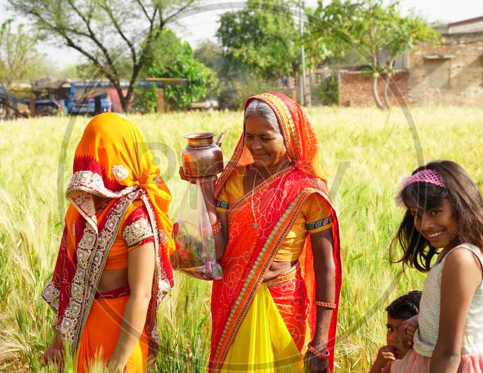 Facial Shot Of Traditional Indian Women With Cultured Dresses. Hindu Women Going To Worship God Through Agriculture Field.