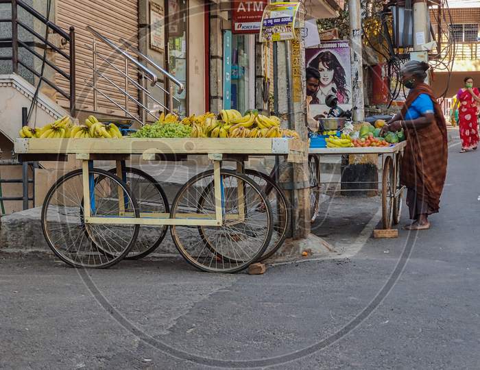 Bangalore, Karnataka, India-15Th February 2021; Stock Photo Of A Male Fruit And Vegetable Seller Wearing Casual Cloth Selling Fruits To Customer In The Morning At Bangalore City Karnataka India