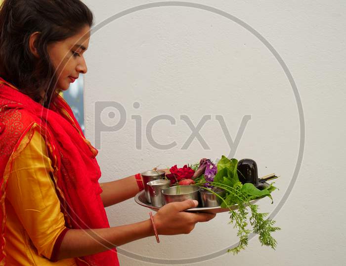Beautiful Girl Holding A Sacred Plate To Worship God. Teen Aged Girl With Shivlinga Statue And Sacred Bael Or Bilv Leaves Closeup.