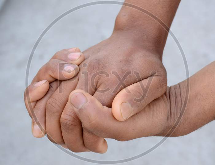 Joint Hands Mental Awareness Health Concept On The Grey Background.