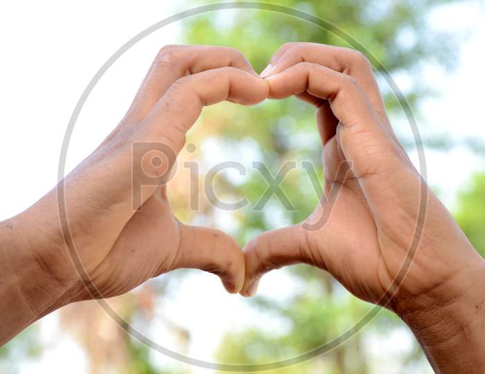 Heart Shape Hands Mental Awareness Health Concept Focus On The Green Background.
