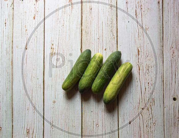 Top view of fresh cucumbers on a background
