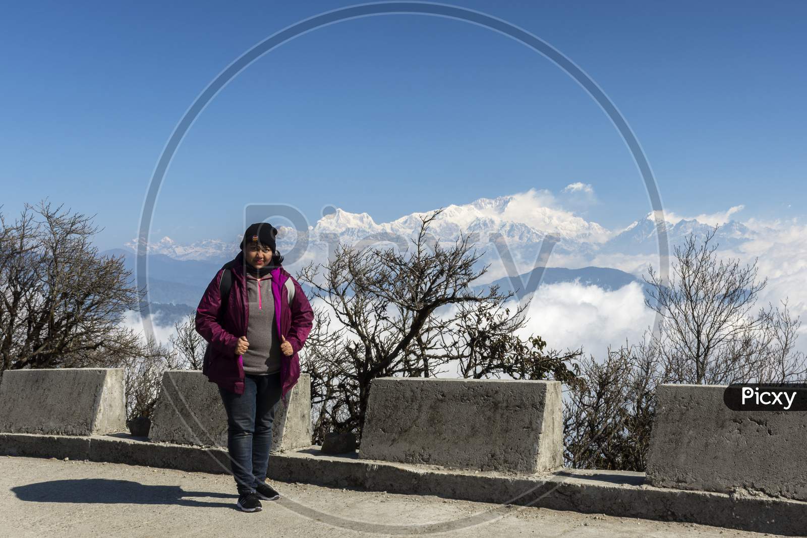 A Female Traveler Standing At A View Point And Enjoying The Beauty Of Himalyan Range.