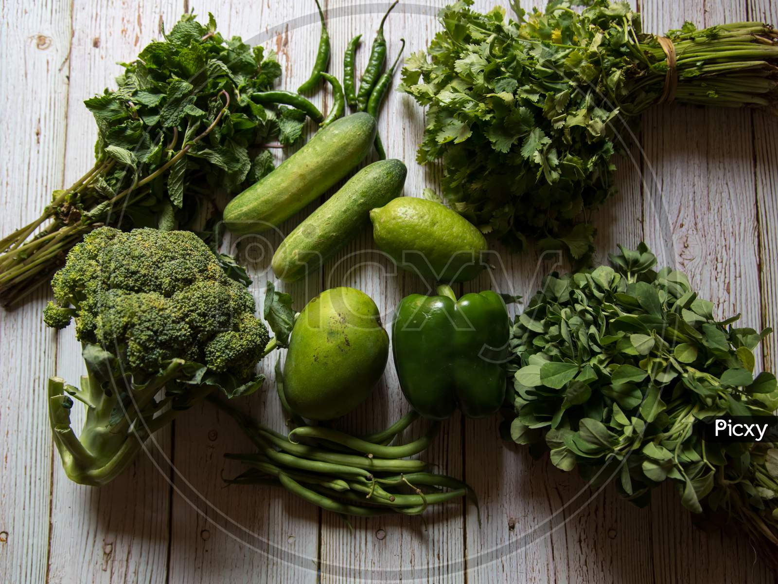 View from above of fresh vegetables on wooden background.