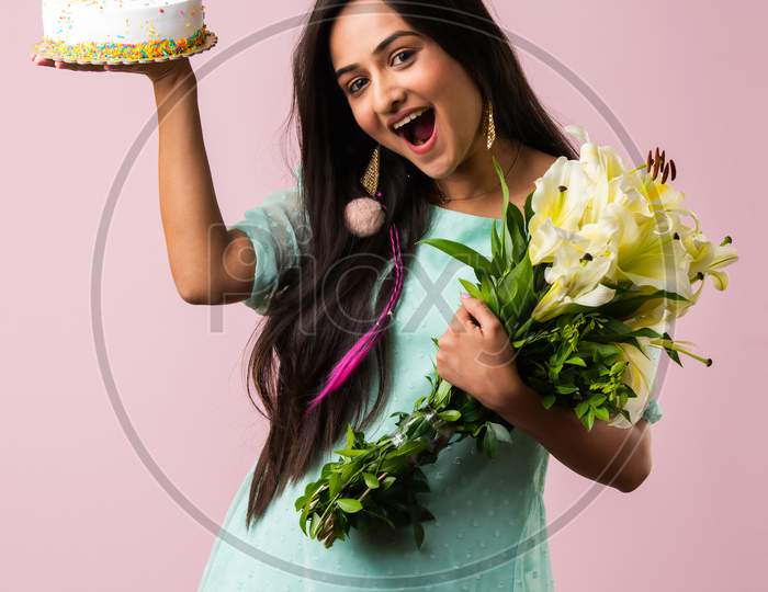 Happy Indian Asian Girl Standing With Flowers Bouquet And Cake