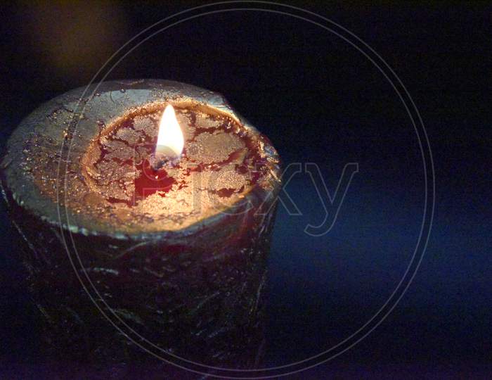 Top Of The Birning Candle With Golden Layer Ob The Red Wax