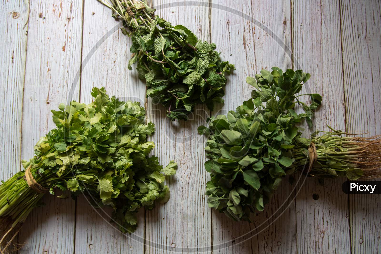 Top view of fresh aromatic herbs on wooden background.