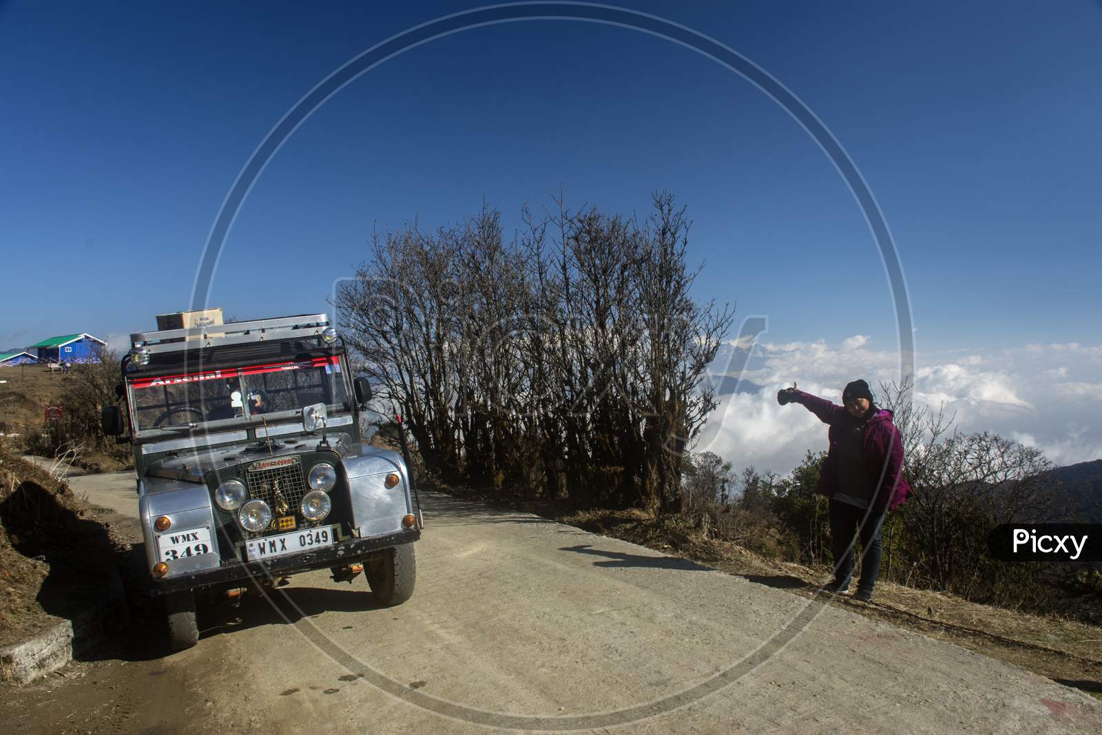 20 March, 2020, Sandakphu, West Bengal, India: A Female Traveller Standing Beside A Old Land Rover Car At Sandakphu, West Bengal.