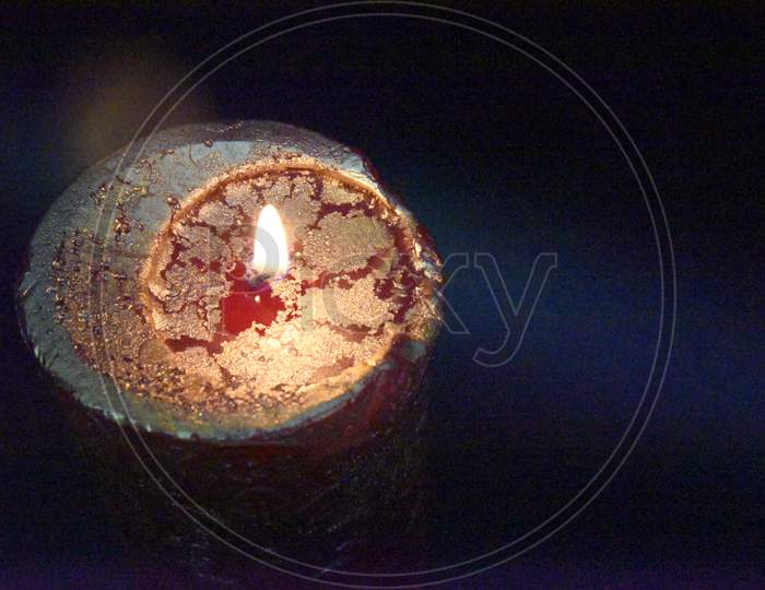 Top Of The Birning Candle With Golden Layer Ob The Red Wax