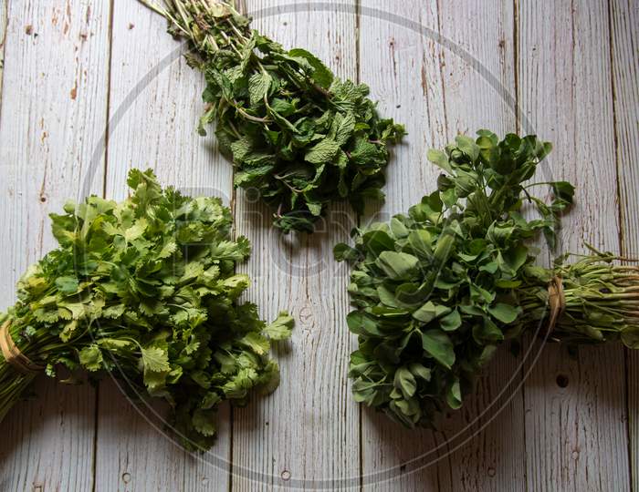 Top view of fresh aromatic herbs on wooden background.