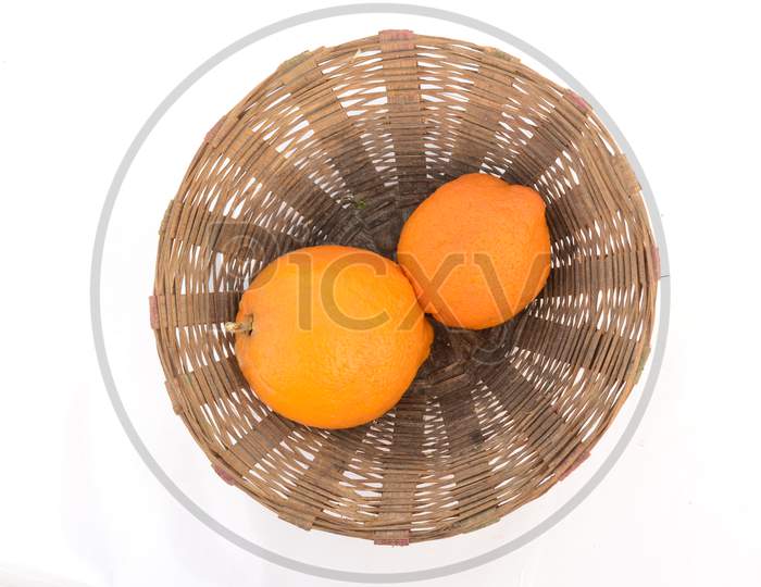 The Pair Of Orange Color Grapefruit In The Basket Isolated On White Background.