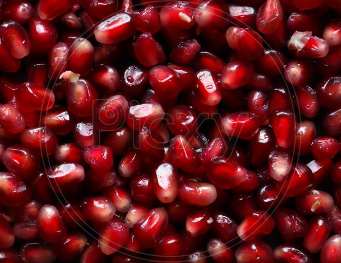 Macro Photography Of A Handful Of Pomegranate Seeds For Food Background