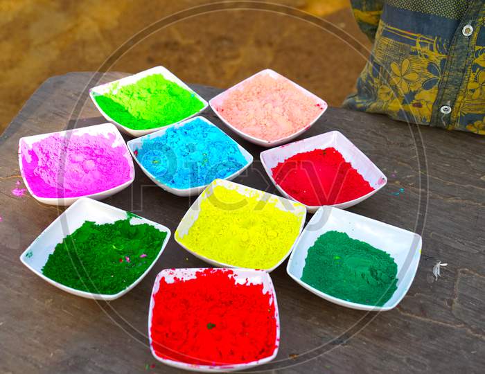 Holi color powder. Organic Gulal colours in bowl for Holi festival