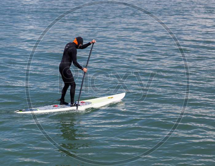 Paddling Surf Board Out Of Sausalito Marina
