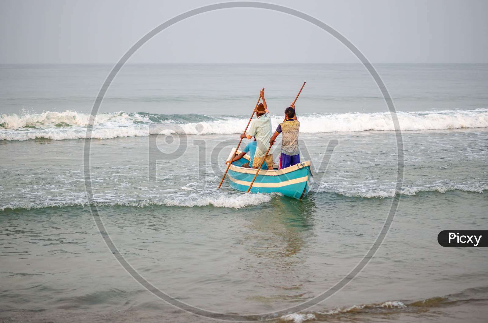 Fishermen Using Traditional Indian Fishing Boat At The Beach Of Maharashtra