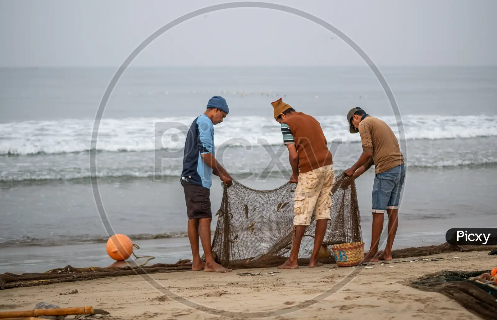 Indian fisherman carrying freshly catch fish at Malvan beach at Photograph  by Snehal Pailkar - Pixels