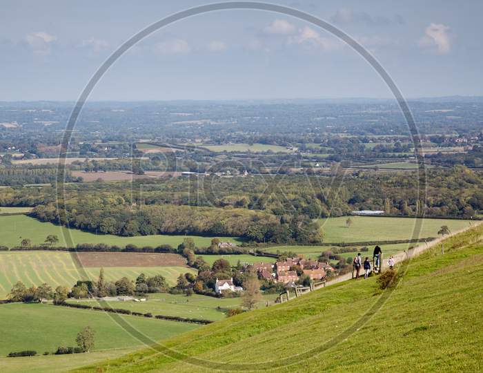People Waking  Over The Rolling Sussex Countryside Near Brighton