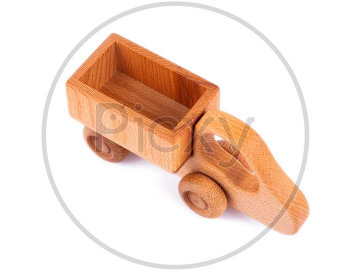 Close-Up Children'S Toy Made Of Natural Wood In The Form Of A Dump Truck  On A White Isolated Background. Studio Photography. Eco-Friendly Toy For Parents And Children