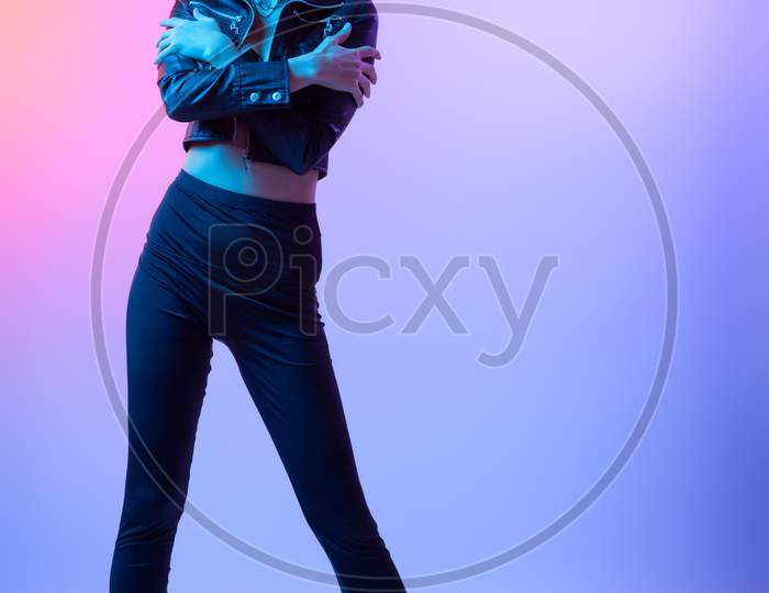 Cinematic Night Portrait Of Woman In  Neon. High Fashion Model Girl In Colorful Bright Neon Lights Posing In Studio, Portrait Of Beautiful Woman In   Coat And Trousers.