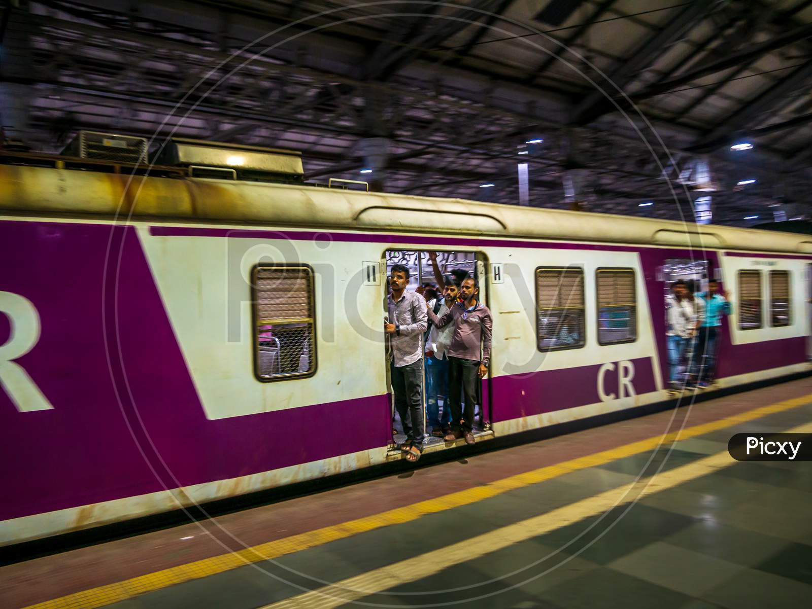Unidentified Passengers Standing On The Door Of Moving Local Train In Mumbai