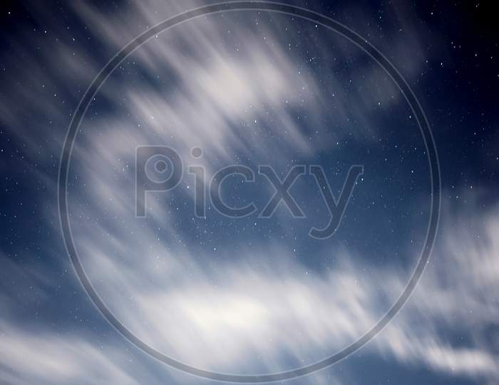 Blurry Clouds Floating In The Sky During Evening With Stars. Used Long Exposure.