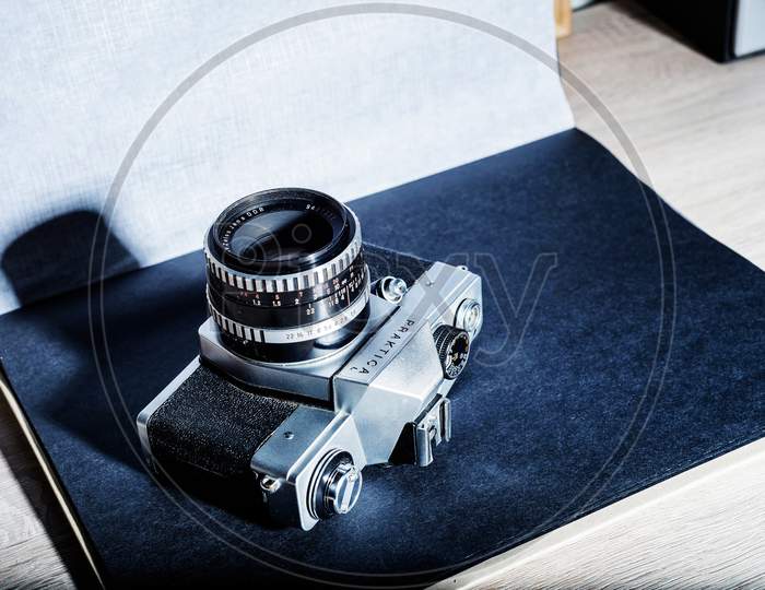 Old film retro camera  on a black photo album