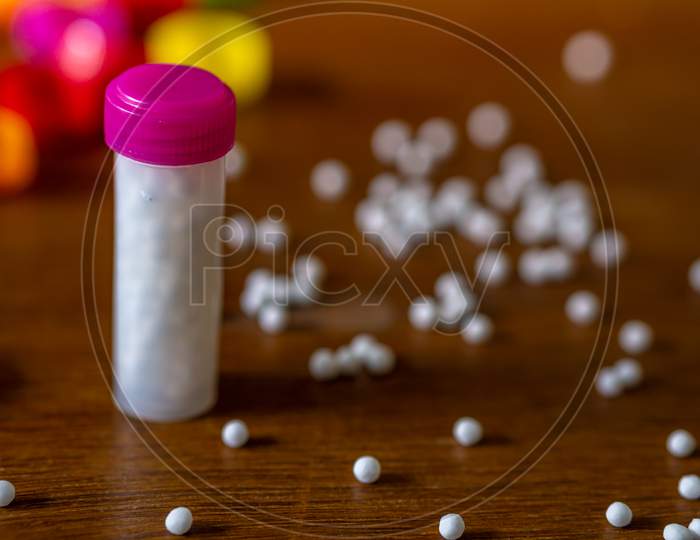 Bottles Filled With White Homeopathic Pills