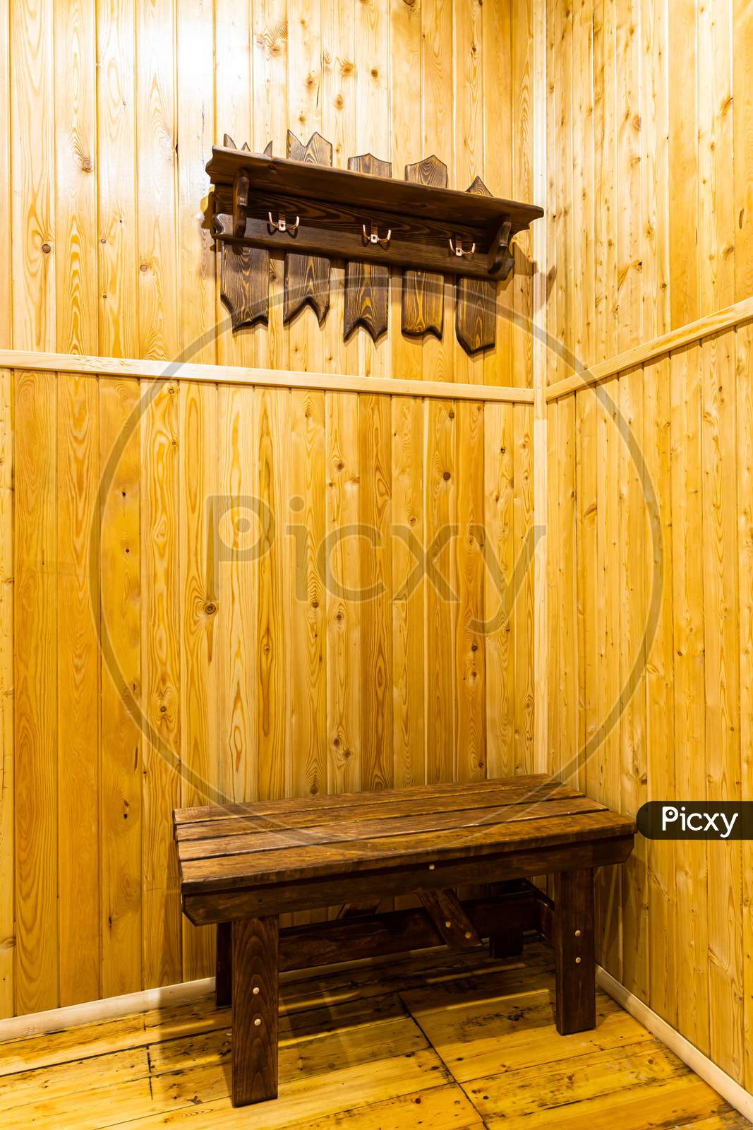 Close-Up Of Wooden Hangers For Upper Clothes, Made By Hand From Wood In The Hallway Of The House. View Of The Corridor In A Country House In Wooden Walls And Floor