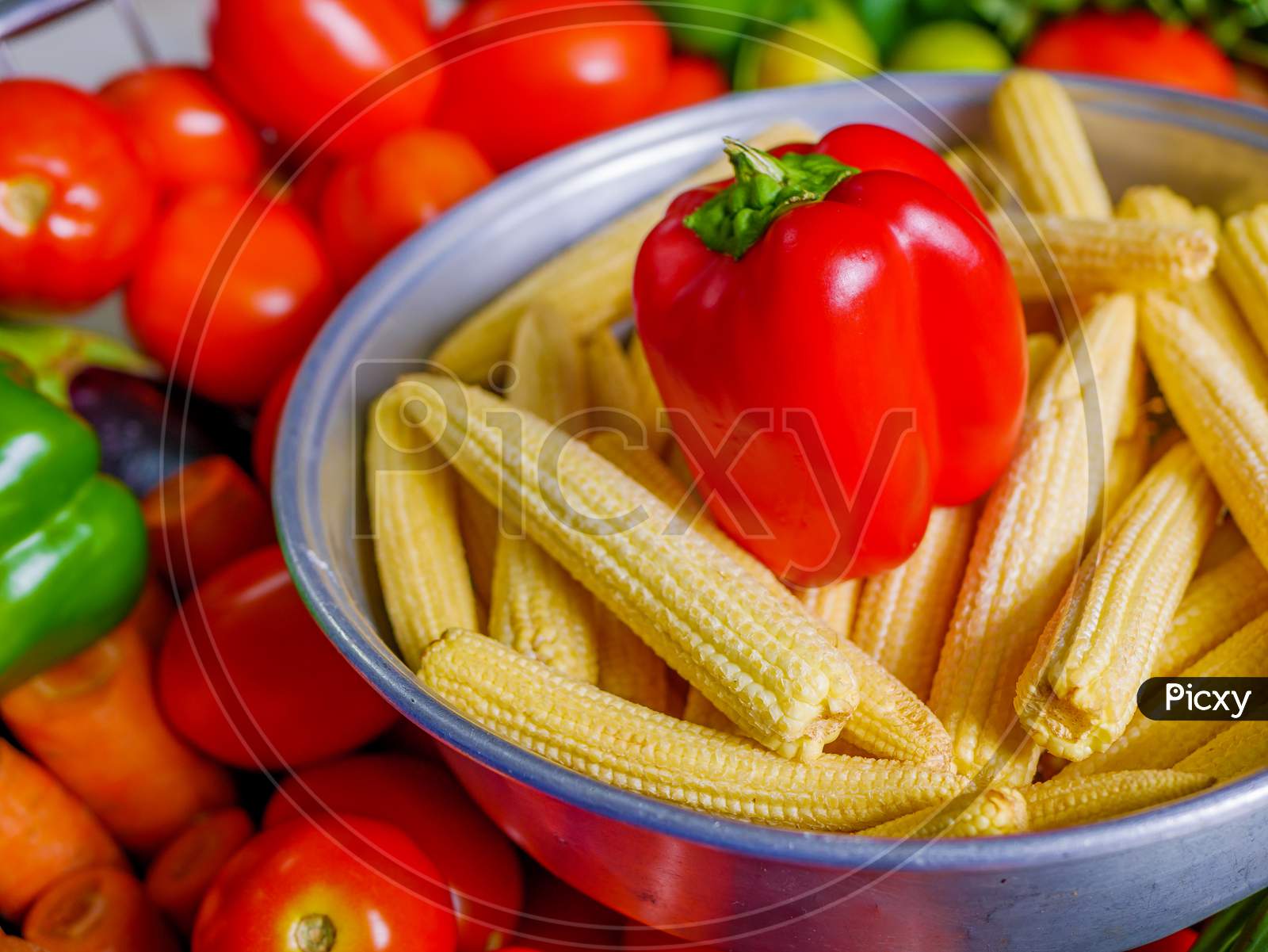 Red Capsicum And Baby Corns Arranged In A Basket