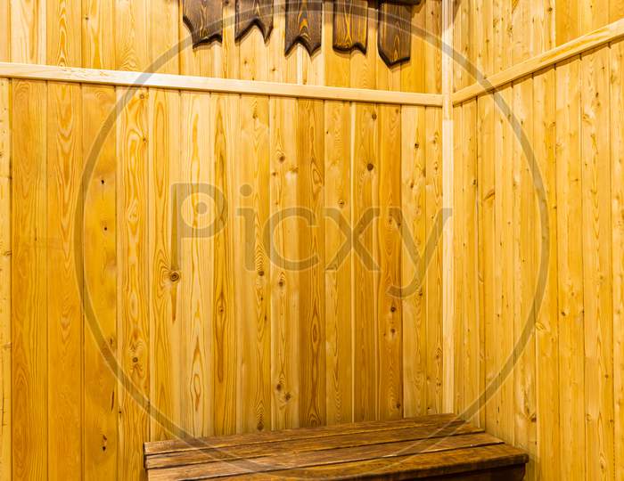Close-Up Of Wooden Hangers For Upper Clothes, Made By Hand From Wood In The Hallway Of The House. View Of The Corridor In A Country House In Wooden Walls And Floor