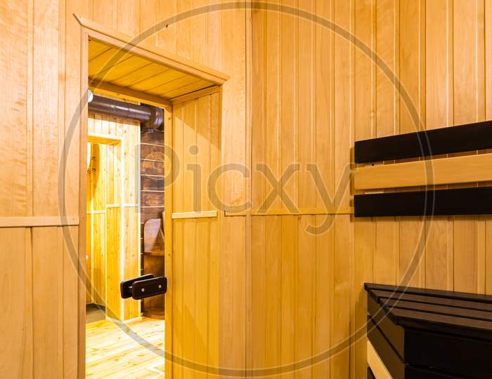 Corridor In Front Of The Entrance To The Bath With Wooden Walls