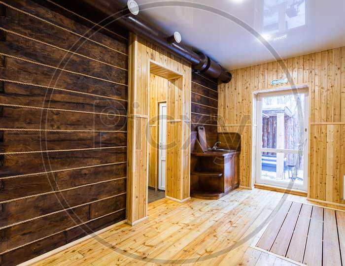 Сorridor Of A Country House: Wall And Floor, Decorated With Clapboard, Wooden Sink With Board And A Large Window