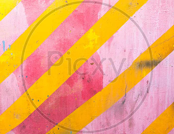 Pink Wall With Yellow Diagonal Stripes, Texture Grunge Background. Geometric Colorful Wall