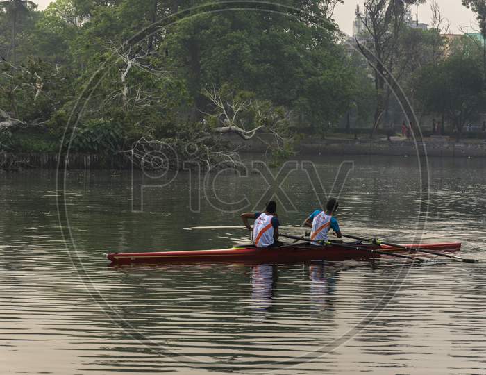 Two Rowers Resting While Rowing In The Morning At Rabindra Sarobar Lake, Kolkata. Concept Of Healthy Living.