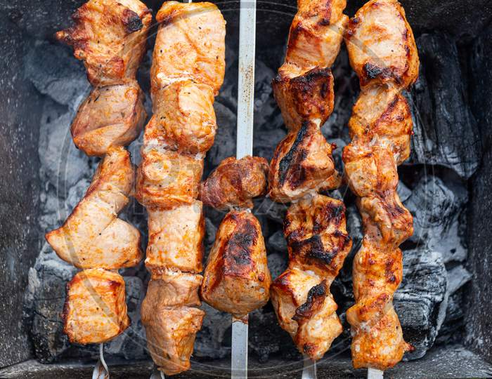 A Close-Up Of The Pies Of Pork In Teriyaki Sauce Is Fried  On Skewers. Preparation Of A Shish Kebab On A Summer Day