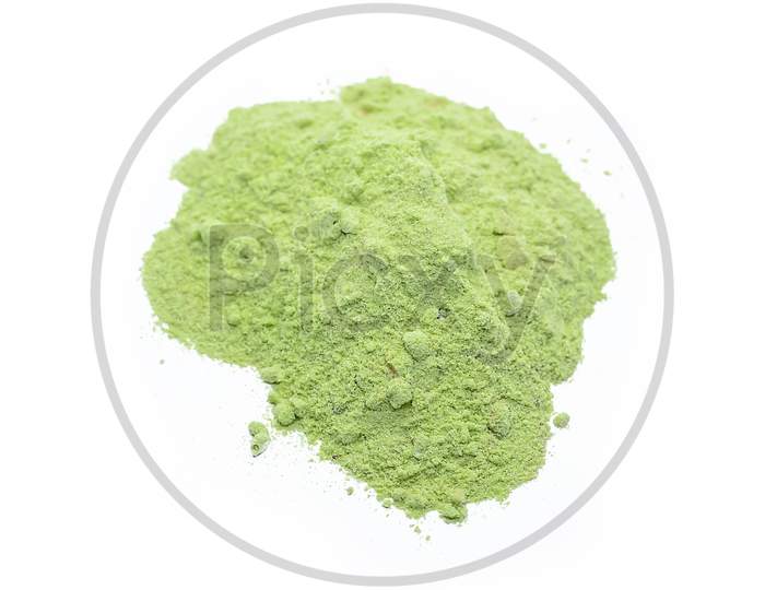 Piles Of Green Color Powder For Indian Holi Festival On White Background.