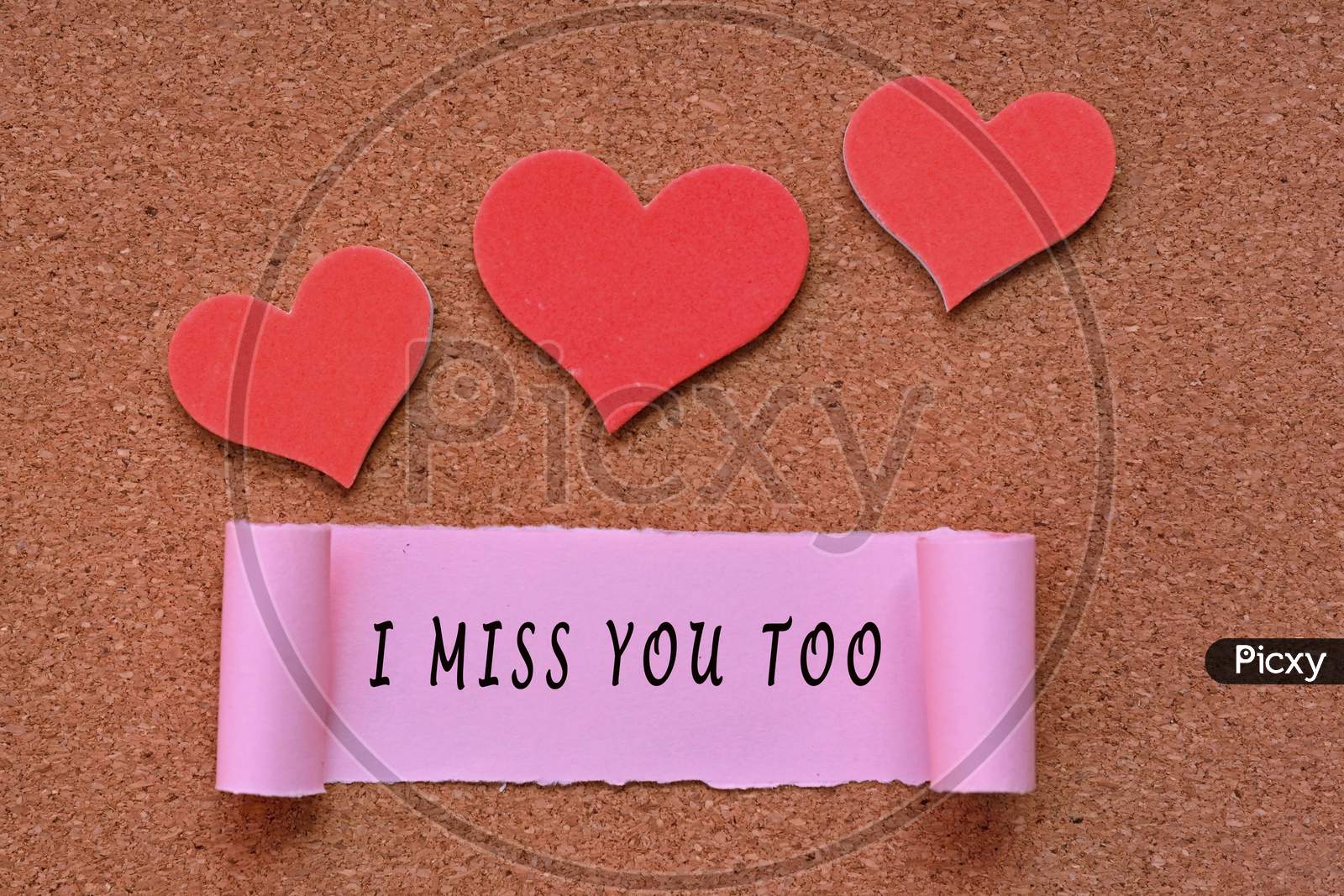 I Miss You Too Label On Torn Paper With Heart Shape On Wooden Background