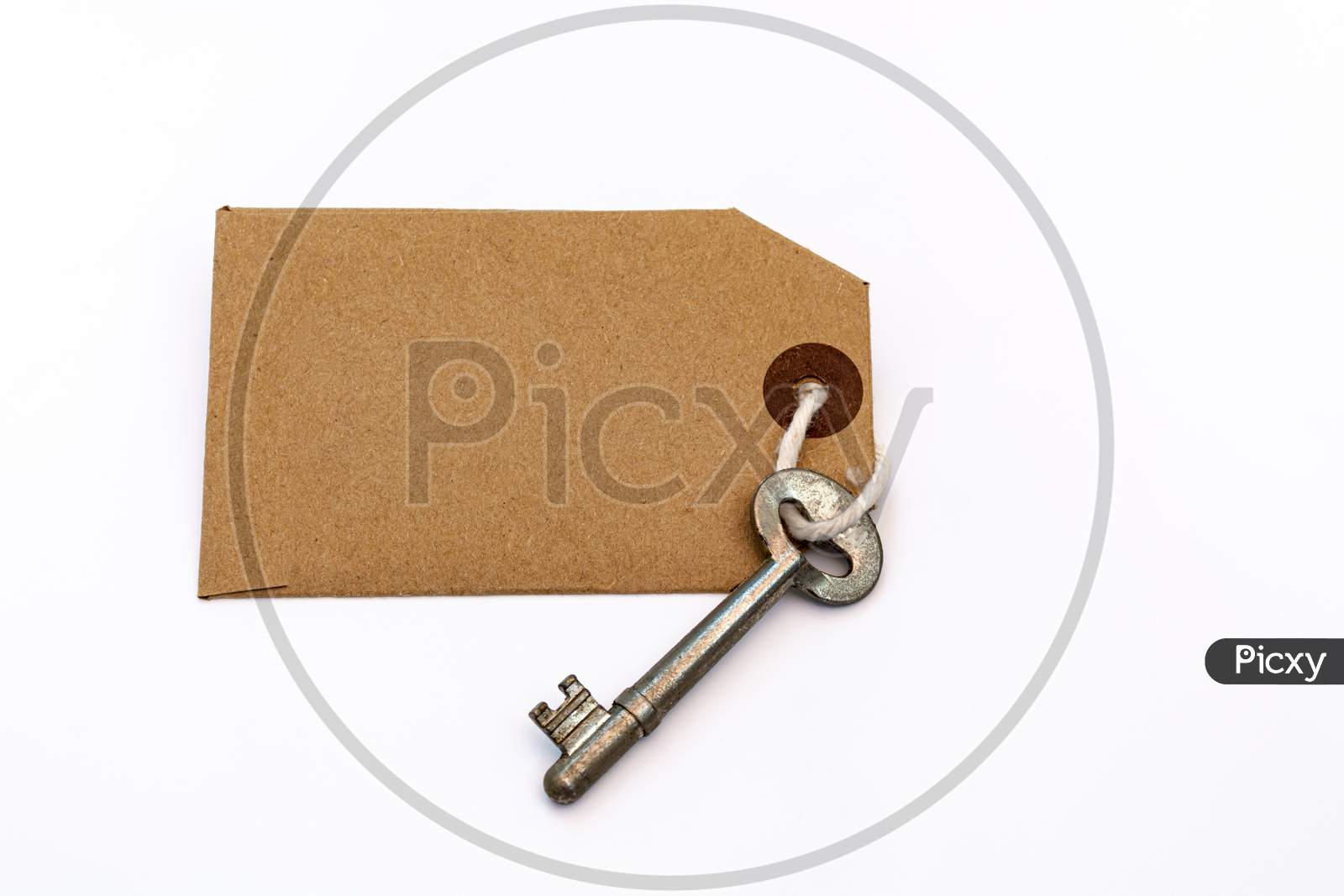 Key And Blank Brown Paper Tag On White Background