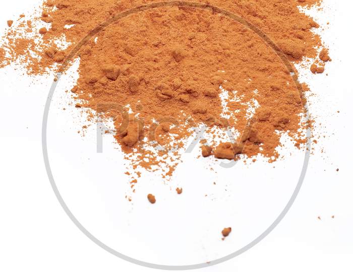 Piles Of Orange Color Powder For Indian Holi Festival On White Background.