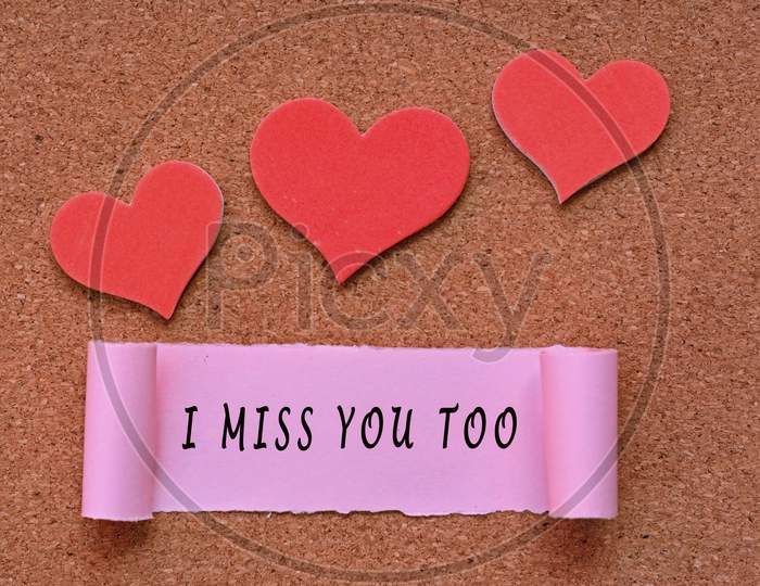 I Miss You Too Label On Torn Paper With Heart Shape On Wooden Background