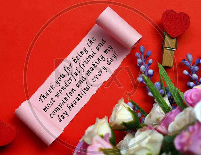 Text Label On Torn Paper With Flowers And Heart Shape Clothespin On Red Background. Valentine'S Day Concept