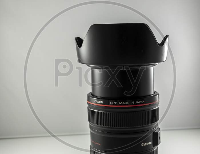 Frankfurt, Germany -March 21st 2021: A german photographer taking detailed pictures of his Canon EF 24-105 L F4.0 lens in order to sell it on eBay after changing his camera system from EF to RF mount.