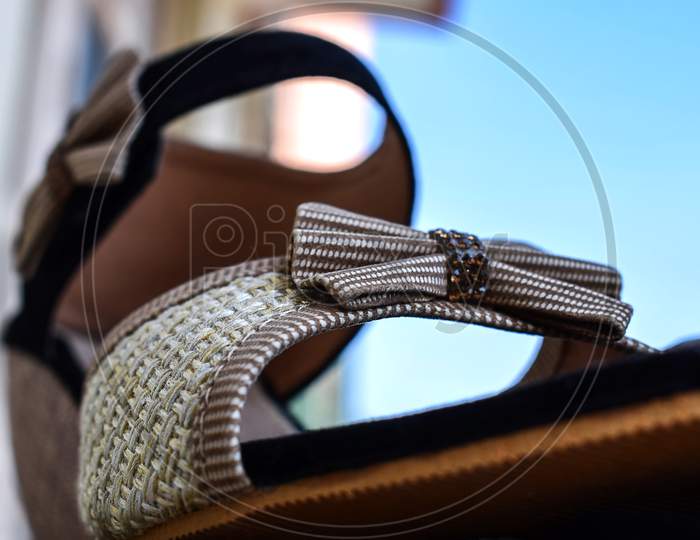 Stock Photo Of Beautiful Pair Of Black And Cream Color High Heel Sandals Displayed On Blur Background,Kept On Table Under Bright Sunlight At Bangalore City Karnataka India.